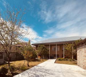 a large brick building with a driveway at The House 39 in Sheki