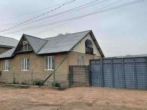 a house with a metal roof and a fence at Daniel guesthouse in Kochkorka