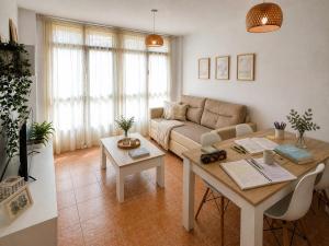 a living room with a couch and a table at Alojamiento Ultreia - Estorde in Cee