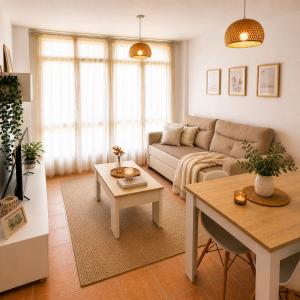 a living room with a couch and a table at Alojamiento Ultreia - Estorde in Cee