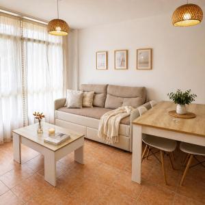 a living room with a couch and a table at Alojamiento Ultreia - Estorde in Cee