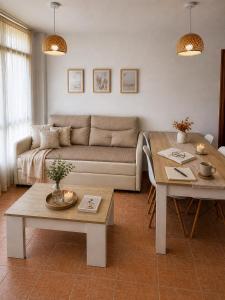 a living room with a couch and a table at Alojamiento Ultreia - Estorde in Cee +43 photos