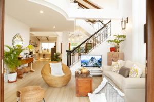 a living room with a couch and a tv at Balay Pahuwai Bed & Breakfast in Tagaytay