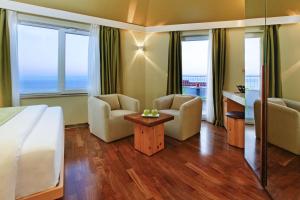 a hotel room with a bed and two chairs and a table at Boutique Hotel Bol in Bol +30 photos