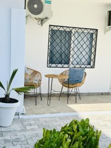a patio with chairs and a table and a fan at Villa Almadies in Pointe-Noire +20 photos