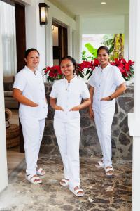three people in white uniforms posing for a picture at Balay Pahuwai Bed & Breakfast in Tagaytay +33 photos