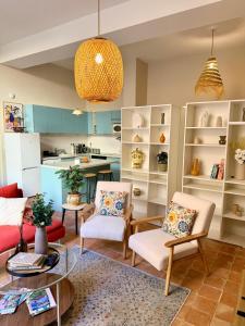 a living room with two chairs and a table at T2 monument historique Aix en provence in Aix-en-Provence +13 photos