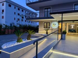 a building with stairs and plants in a courtyard at Hotel Futuro in Aversa