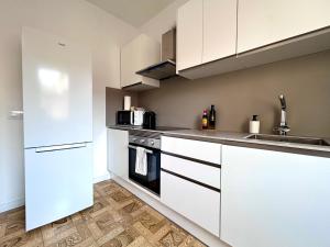 a kitchen with white cabinets and a sink at Caliu Tremp in Tremp
