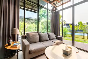 a living room with a couch and a table at Ombra House No. 21-24 in Chiang Mai