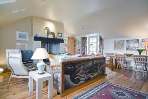 a kitchen and living room with a table and chairs at The Dick Turpin Cottage in Clun