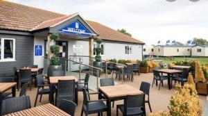 a patio of a restaurant with tables and chairs at Seaview Holiday Rentals - Arizona pet friendly in Chestfield