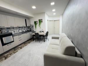 a living room with a couch and a table at Ali apartments in Pizzo