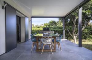 an outdoor dining room with a table and chairs at Villa bord de mer piscine, jacuzzi in Hyères +21 photos