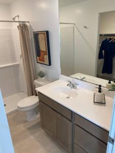 a bathroom with a sink and a toilet and a mirror at Todd's Relaxation Place in Maricopa