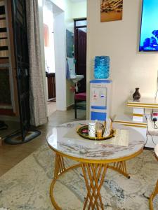 a coffee table in a living room with a drink on it at Cozy cloud in Ruiru