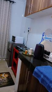 a kitchen with a black counter top and a stove at Cozy cloud in Ruiru +5 photos