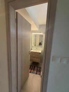 a bathroom with a sink and a mirror at Flo's Apartments in Missolonghi