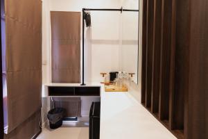a bathroom with a shower and a toilet in it at Continuum Hotel Udonthani in Udon Thani