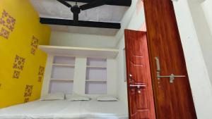 a room with a bed and a wooden door at singh homestay in Varanasi