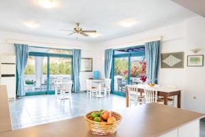 a kitchen and dining room with a table and chairs at Blue Sea Hotel in Amoopi