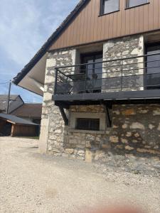 a building with a balcony on the side of it at La Fraternelle in Ceyzérieu
