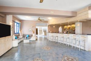 a lobby with a bar with stools at Blue Sea Hotel in Amoopi