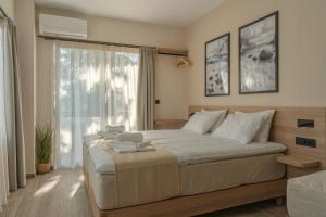 a bedroom with a large bed and a window at Varvara's Diamond - Adults Only in Platanes