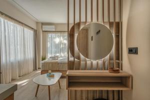 a bathroom with a mirror and a table at Varvara's Diamond - Adults Only in Platanes