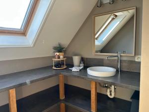 a bathroom with a sink and a mirror at Au Coeur des Collines, Gloriette in Ellezelles +15 photos