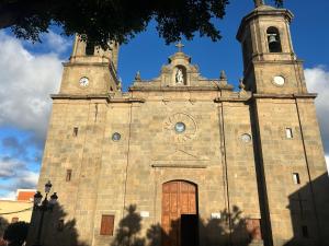 an old church with two towers on top of it at Casa Toñi Airport in Agüimes