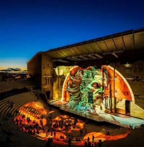 a large auditorium with a painting on the side of a building at Umalas studio in Orange