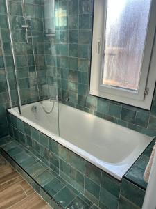 a bathroom with a bath tub and a window at Umalas studio in Orange
