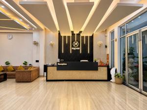 a lobby with a couch and a reception desk at Hotel JB Square Ayodhya Near Ram Mandir, Airport & Ayodhya Cantt in Ayodhya