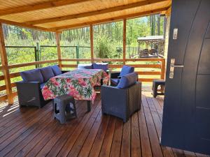 a porch with a table and chairs on a deck at Oto Domek 1 in Międzyrzecz