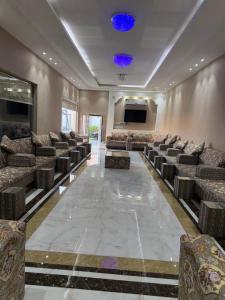 a large room with chairs and a projection screen at شالهيات ريست 2 in Hail