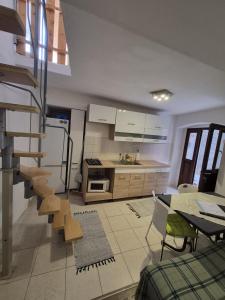 a kitchen with a staircase in the middle of a room at Apartment Sidro in Cres