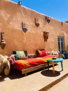 a bed sitting in the side of a building at Merzouga Hotel Activities in Merzouga