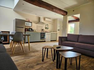 a living room with a couch and a table at Gites de groupes Les Muriers in Bourgvilain