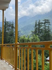 a porch with a view of the mountains at Sparrow Whisper in Jibhi