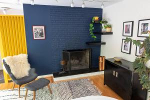 a living room with a blue brick fireplace at Mid-Century Gem Creekside King Beds Near UNC in Chapel Hill