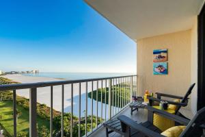 a balcony with a view of the ocean at Waterfront Condo Beach Access & Pool Luxury in Marco Island