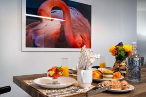 a table with food and a picture of a flamingo at Waterfront Condo Beach Access & Pool Luxury in Marco Island +52 photos