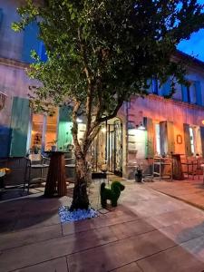a tree on a sidewalk next to a building at Chez Nanou, à proximité de St Emilion in Sainte-Terre