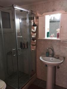 a bathroom with a shower and a sink at mastic flavored sweet in Chios +17 photos