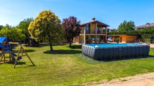 a house with a swimming pool in a yard at Villa Luna Appartements und Spa in Calmasino