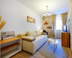 a living room with a couch and a table at Apartments Festum in Šibenik