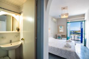 a bedroom with a bed and a sink and a bathroom at Blue Sea Hotel in Amoopi +82 photos