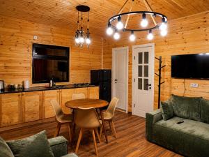 a living room with a table and a couch at Matilda Village in Telavi