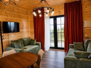 a living room with a couch and a table at Matilda Village in Telavi